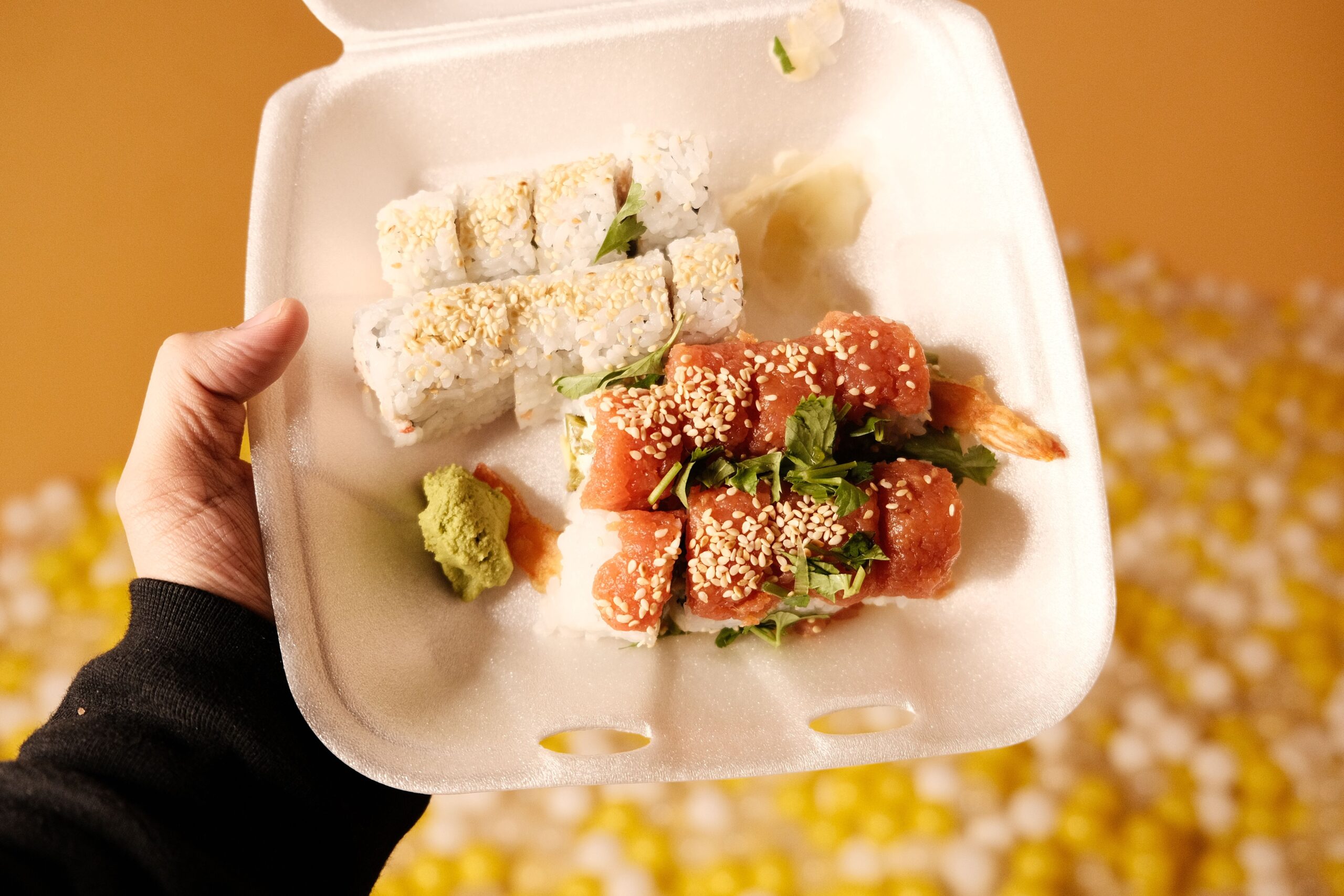 pexels photo 30981171 30981171 Vibrant sushi takeout with assorted rolls in a foam container, ready to enjoy.