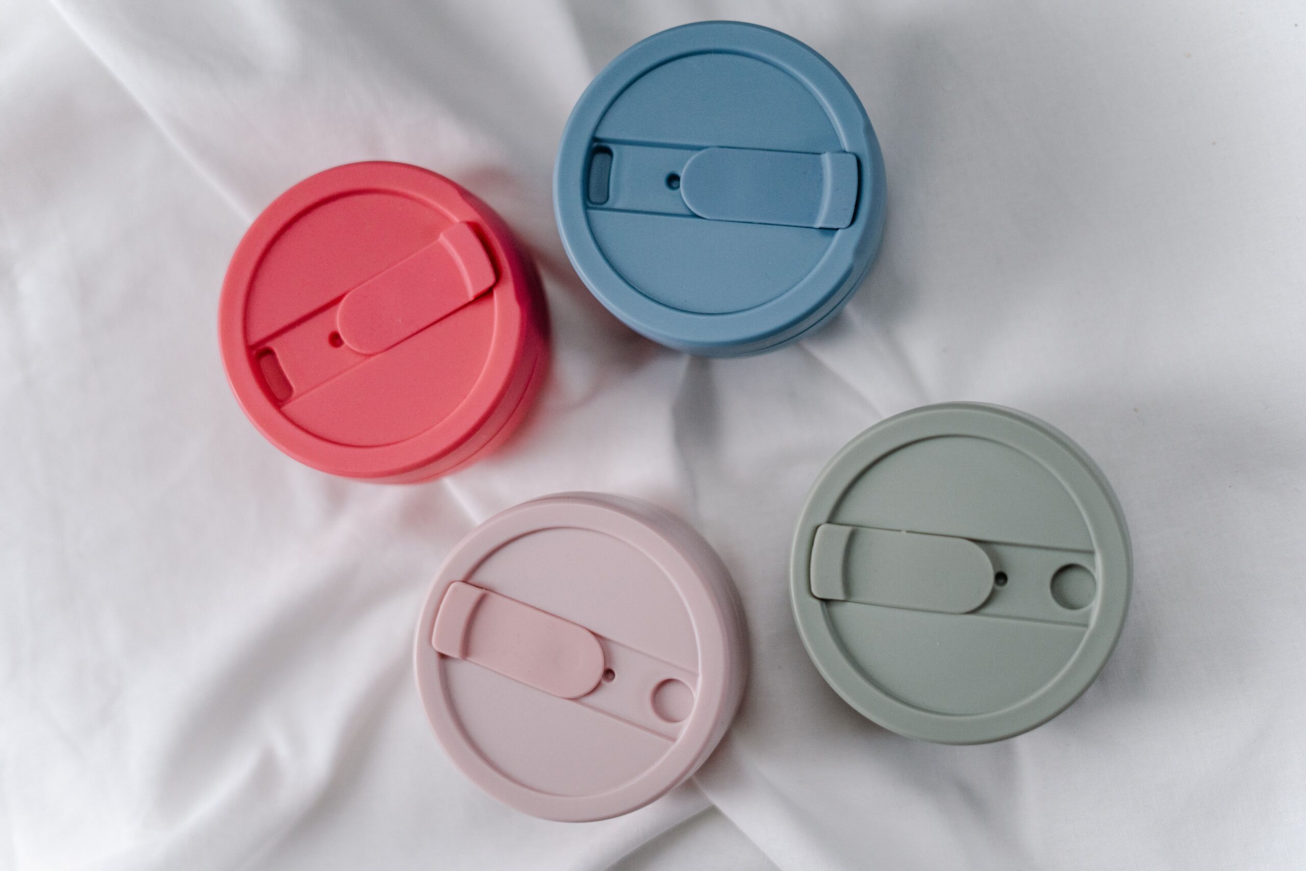 pexels photo 3737801 3737801 A close-up of four colorful, reusable silicone cup lids promoting zero waste.